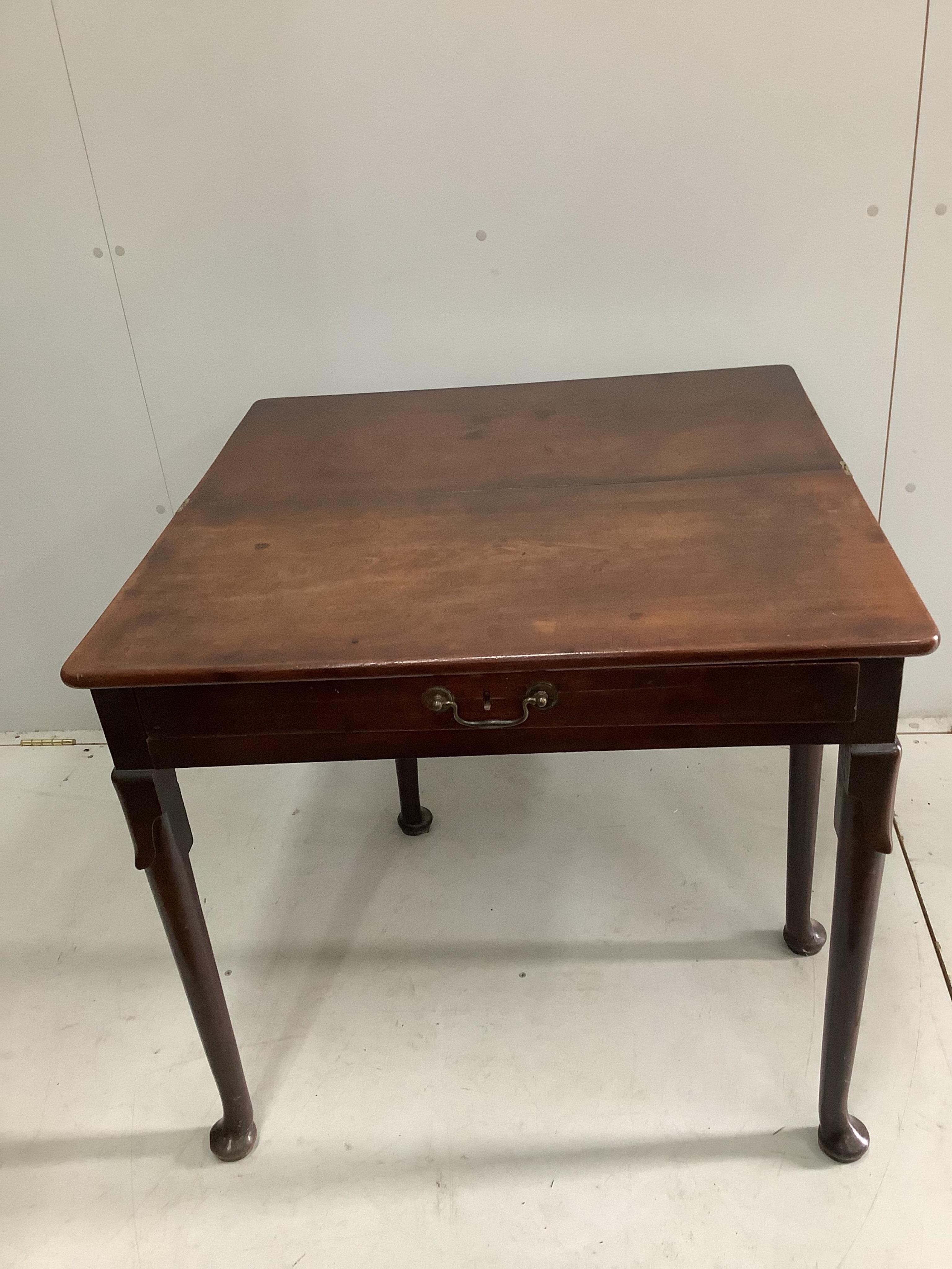 A George II mahogany folding tea table, width 81cm, height 73cm. Condition - fair to good